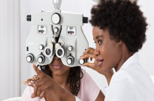 Picture of an optometrist performing an eye examination on a patient