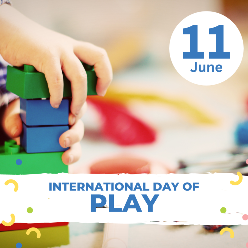 It features a close-up of a child’s hands engaging with colorful interlocking blocks, likely in a play environment. The also includes text overlays. In the top right corner, “11 June” is displayed within a blue circle, and across the bottom, a blue strip carries the bold white text “INTERNATIONAL DAY OF PLAY,” accompanied by decorative elements like confetti and emotive symbols. This emphasizes the importance of playtime for children’s development and well-being.