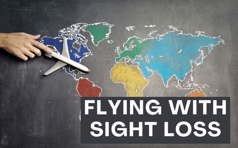 A hand touching an airplane over a chalkboard with a colorful map of the world drawn on it. Below the map, the text “FLYING WITH SIGHT LOSS” is written in large white letters. The suggests themes of travel and accessibility for individuals with visual impairments.