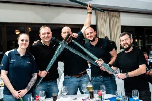 A group photo of one of the teams receiving their prize, pictured with Zenia from Retina SA