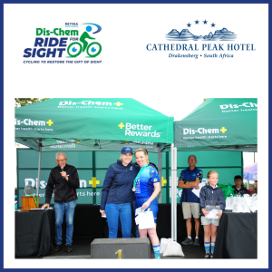 Courtney standing on stage receiving her prize from Linsay Engelbrecht