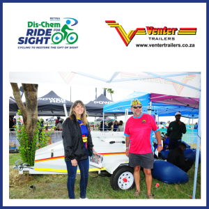 Theo the winner of the Venter Trailer standing in front of the trailer with the representative of Venter Manufacturing to his left