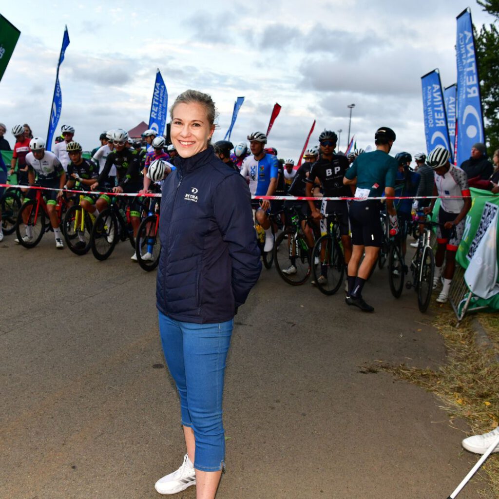 Linsay standing in front of the start line at the DIs-Chem Ride for Sight