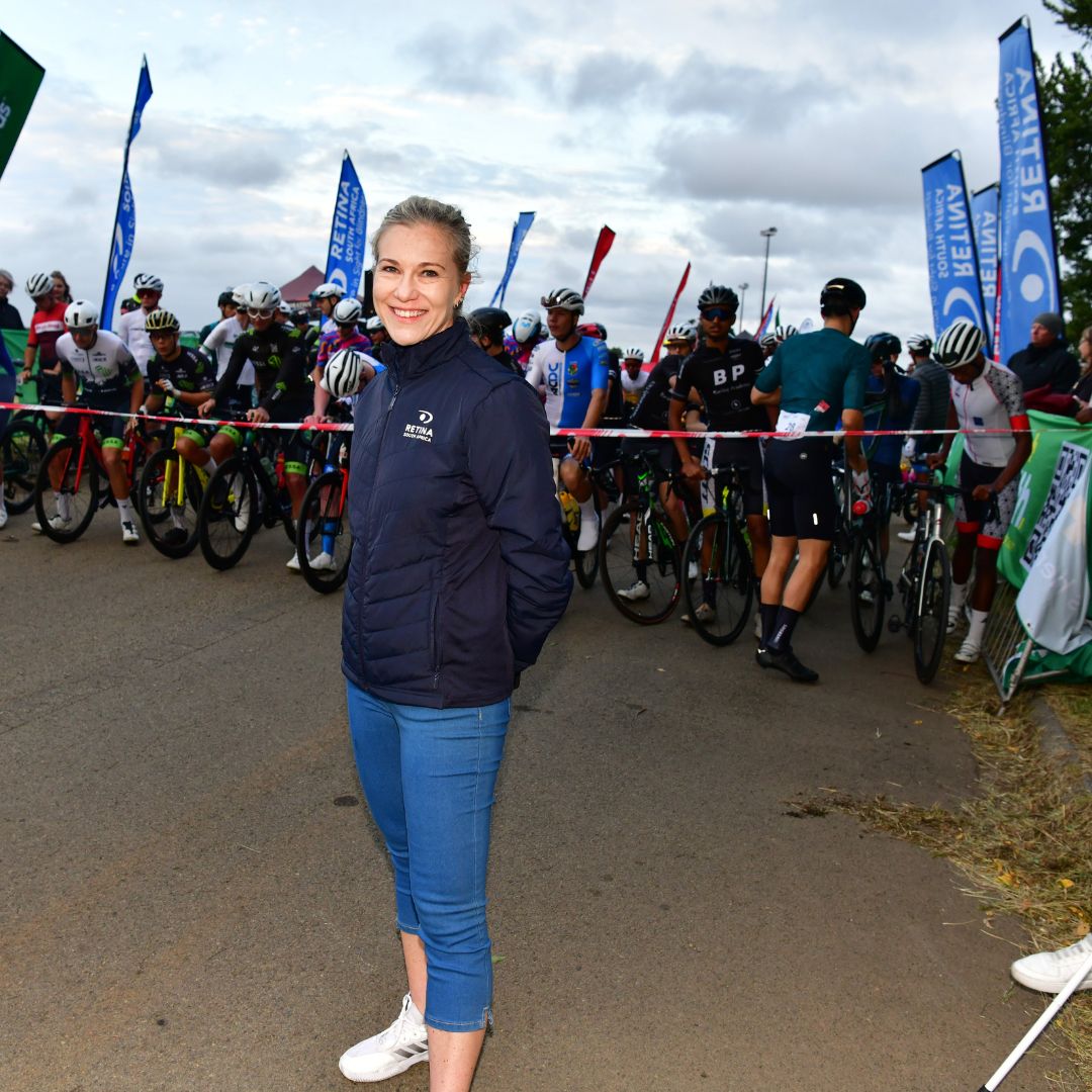 Linsay standing in front of the start line at the DIs-Chem Ride for Sight