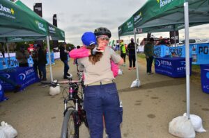 cyclist hugging family or friend