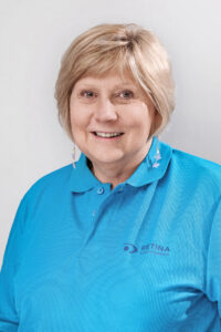 Jean wearing a blue Retina SA Golf Shirt