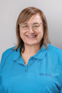 Caryl wearing a blue Retina SA Golf Shirt