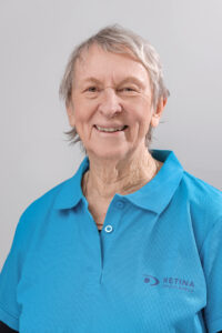Claudette wearing a blue Retina SA Golf Shirt