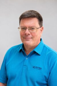 Ferdi Danzfuss wearing a blue Retina golf shirt